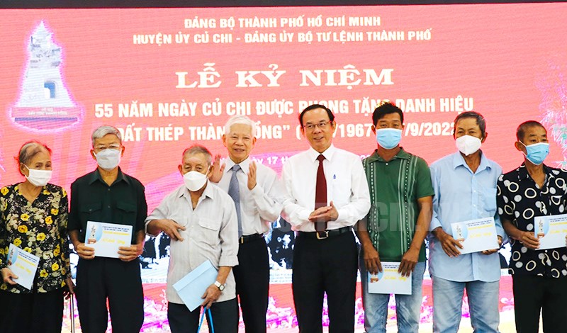 Đồng chí Nguyễn Minh Triết và đồng chí Nguyễn Văn Nên trao quà cho các gia đình chính sách.